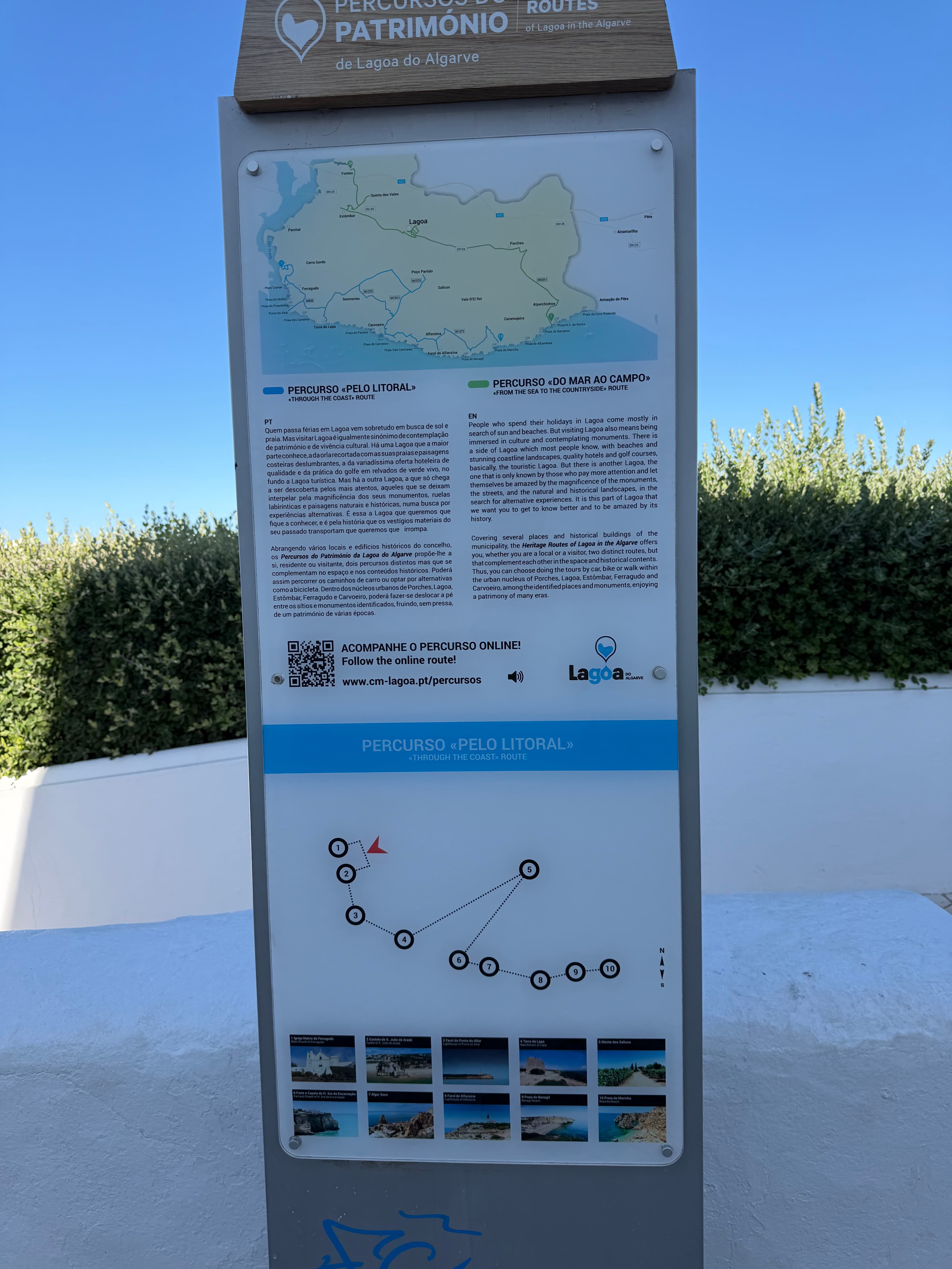 Bilingual heritage routes signboard for Lagoa do Algarve, Portugal, featuring a coastal map and trail waypoints under bright